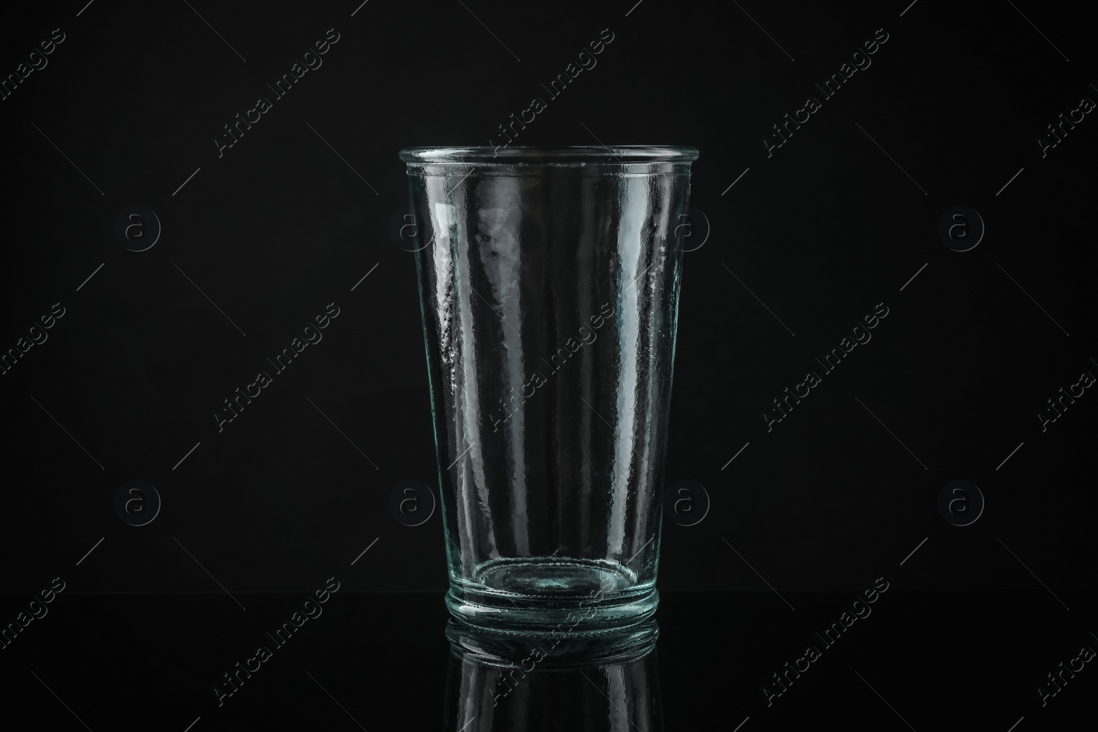 Photo of Elegant empty colorful glass on black background