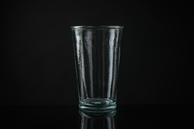 Photo of Elegant empty colorful glass on black background