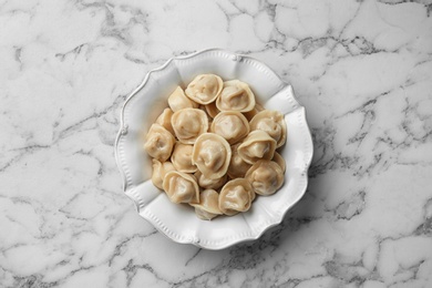 Photo of Tasty dumplings on marble table, top view