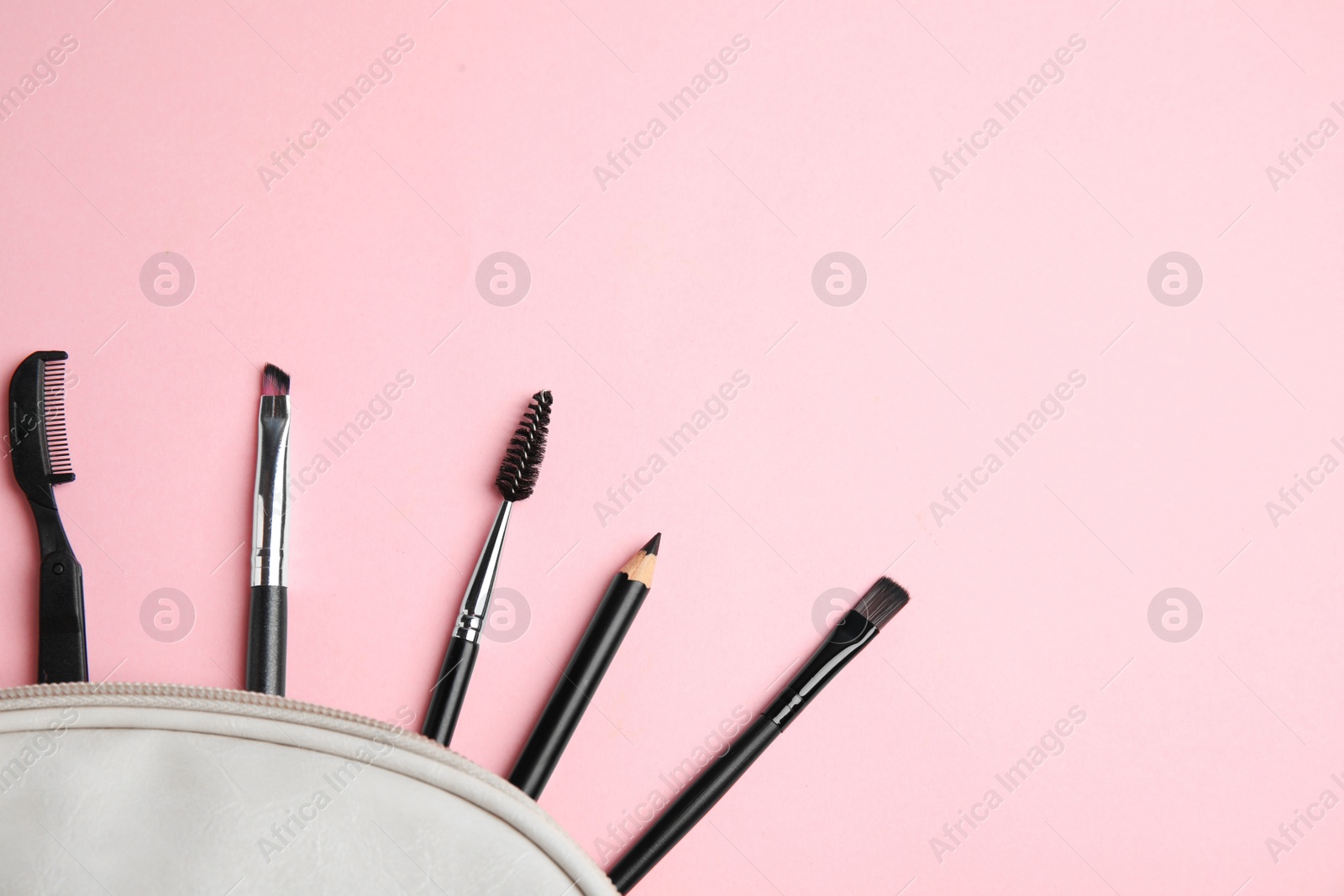 Photo of Set of professional eyebrow tools on pink background, flat lay. Space for text