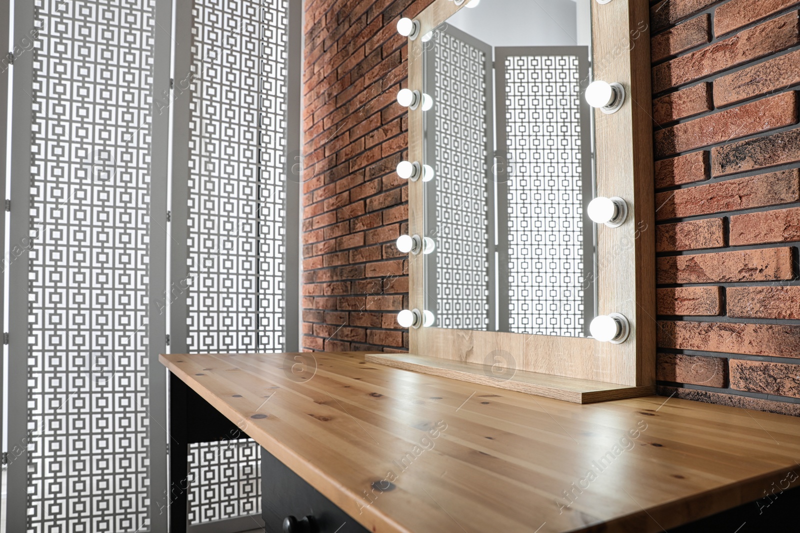 Photo of Makeup room interior with wooden table and large mirror