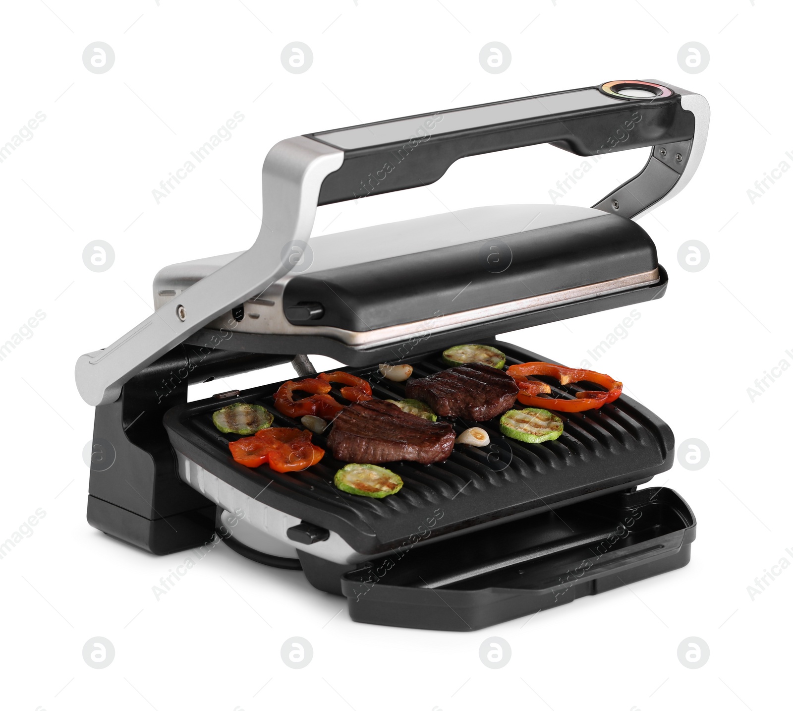 Photo of Electric grill with tasty meat and vegetables isolated on white