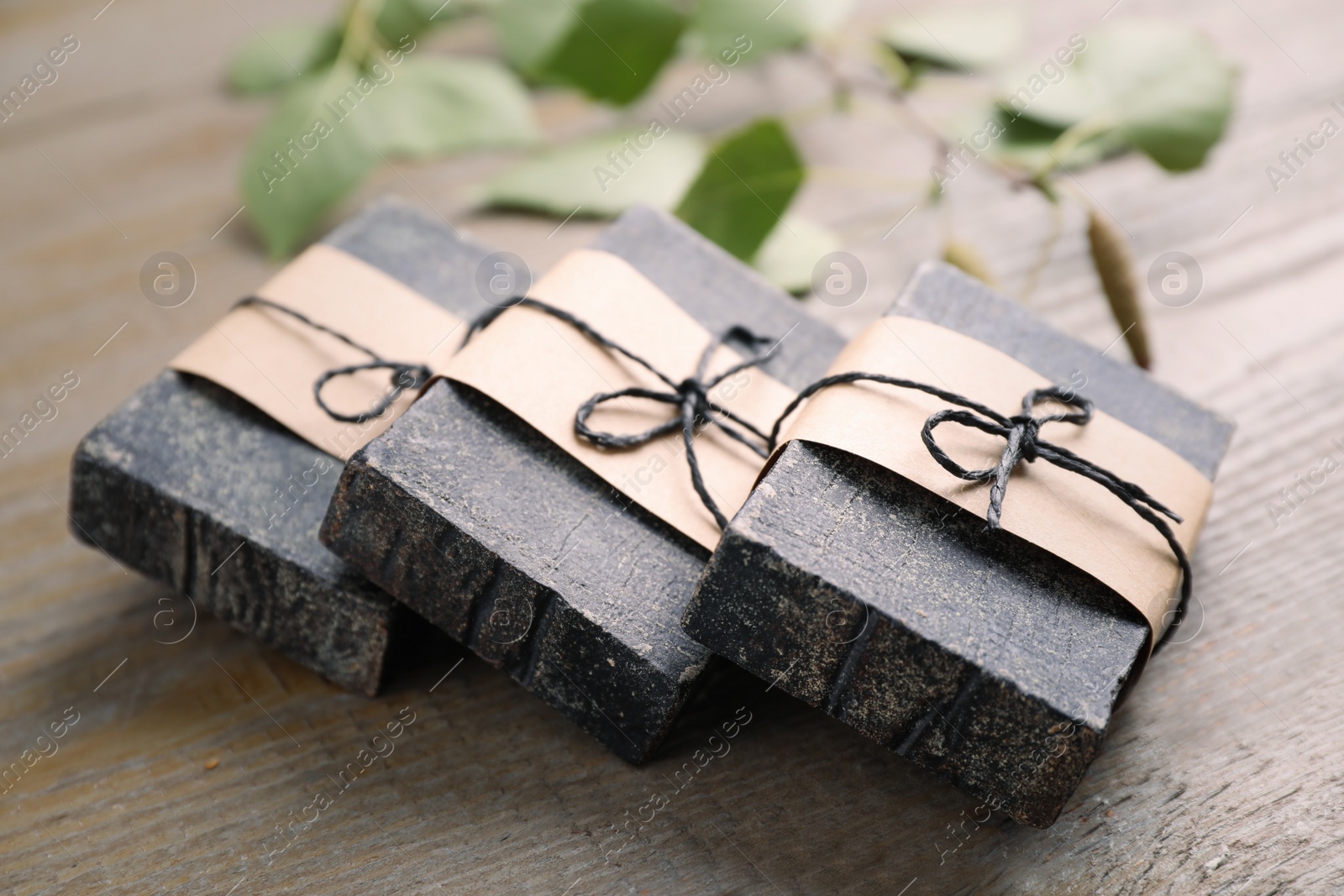 Photo of Natural tar soap on wooden table, closeup