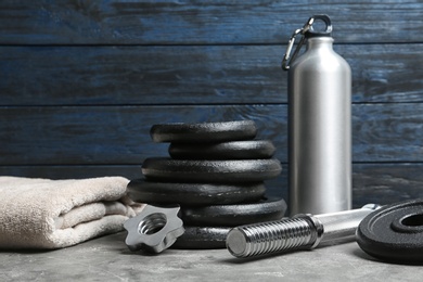 Photo of Composition with dumbbell plates and sport equipment on floor