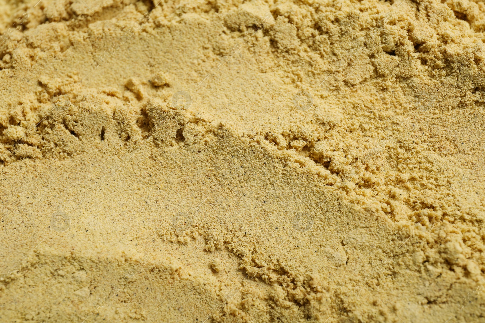 Photo of Aromatic mustard powder as background, top view