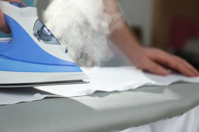 Man ironing clean shirt at home, closeup