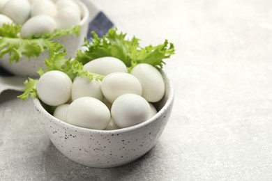 Photo of Peeled boiled quail eggs on grey table, space for text