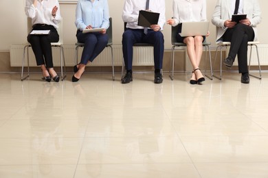 People waiting for job interview in office hall, closeup