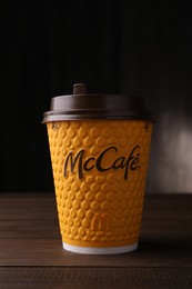 Photo of MYKOLAIV, UKRAINE - AUGUST 12, 2021: Hot McDonald's drink on wooden table