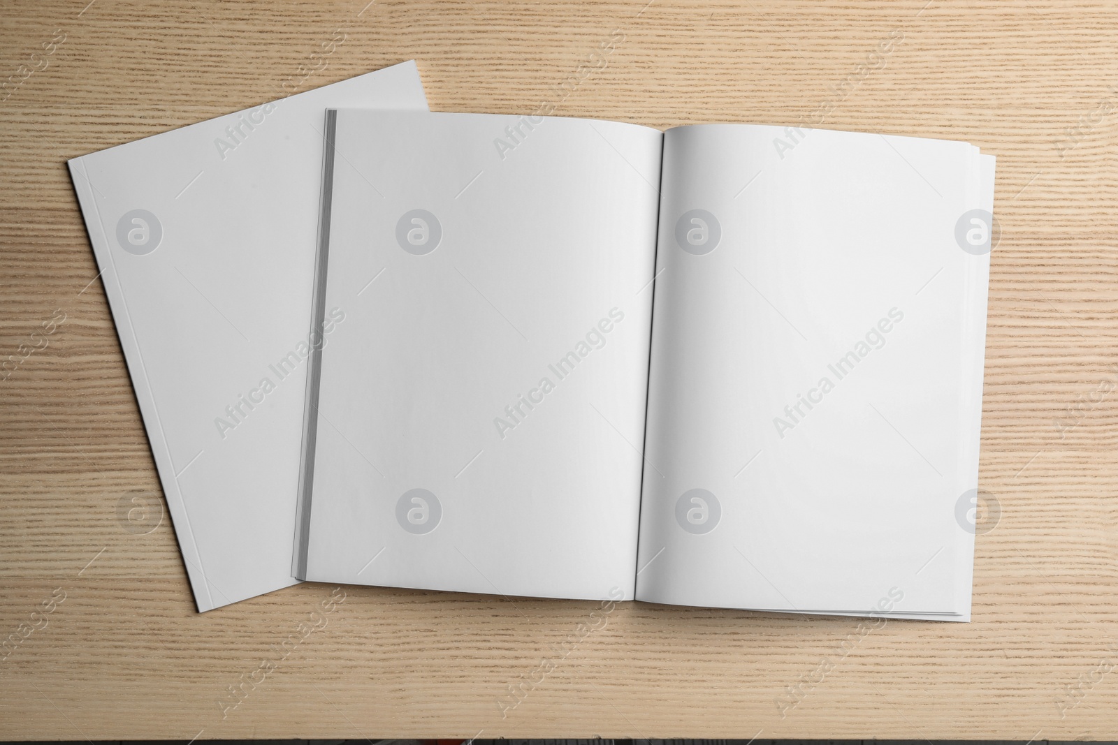 Photo of Open and closed blank brochures on wooden background, top view. Mock up for design