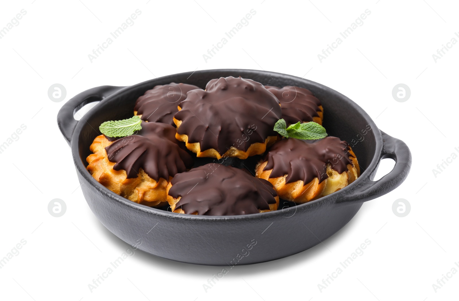 Photo of Delicious profiteroles with chocolate spread and mint in frying pan isolated on white