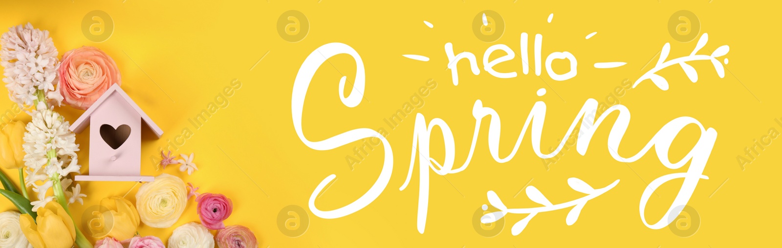 Image of Hello Spring. Wooden bird house and fresh flowers on yellow background, flat lay 