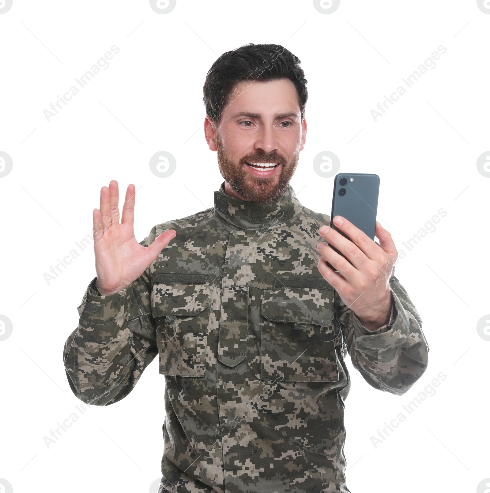 Photo of Happy soldier using video chat on smartphone against white background. Military service