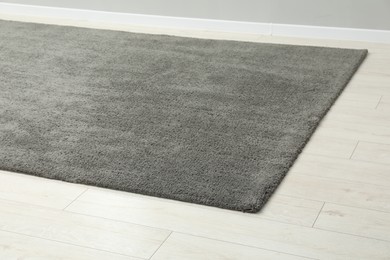 Photo of Soft grey carpet on white laminated floor indoors