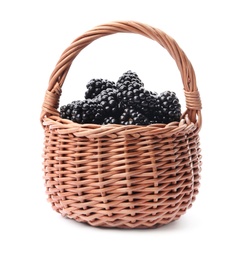 Wicker basket of tasty blackberries on white background