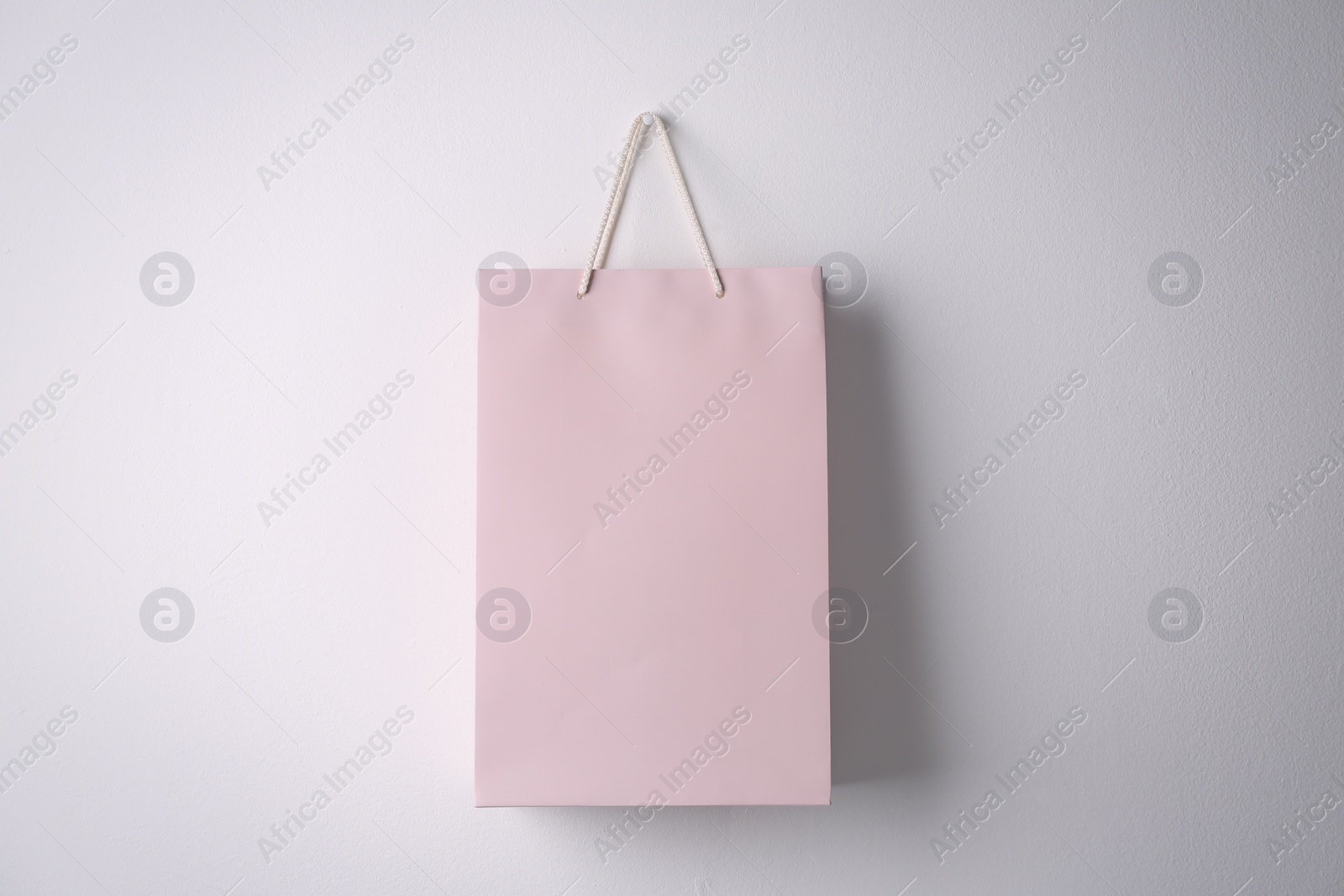 Photo of Paper shopping bag hanging on white wall