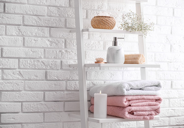 Clean towels on shelving unit in bathroom