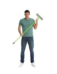 Photo of Man with green broom on white background