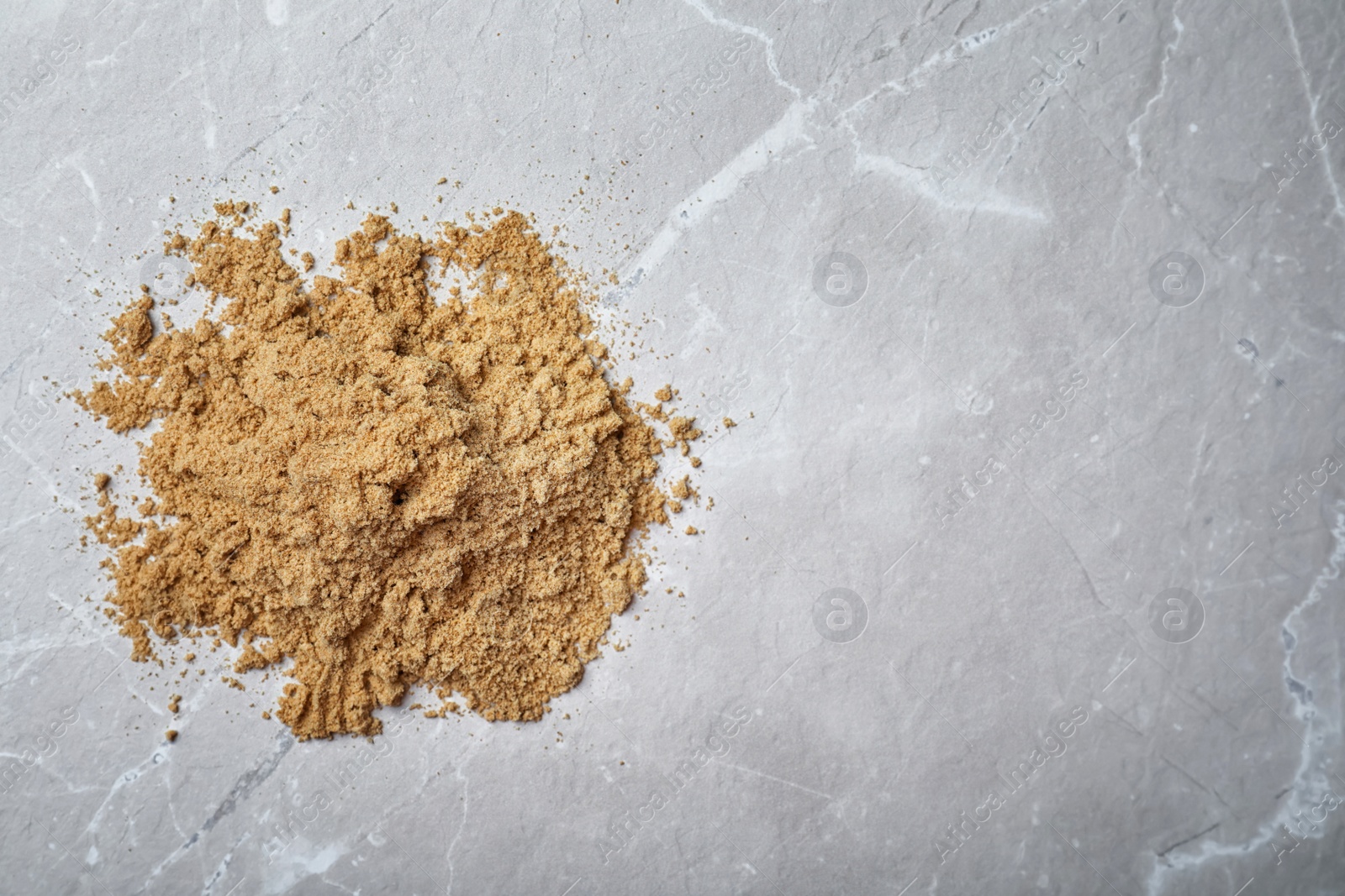 Photo of Pile of pumpkin flour on gray background