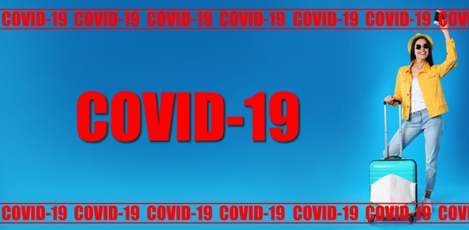 COVID-19 pandemic, travel during coronavirus outbreak. Woman with suitcase and ticket in passport on blue background. Vacation travel