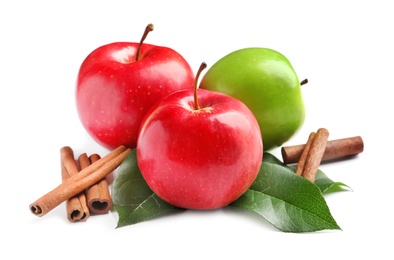 Photo of Fresh apples and cinnamon sticks on white background