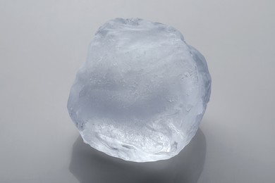 Photo of One crystal clear ice cube on white background, closeup