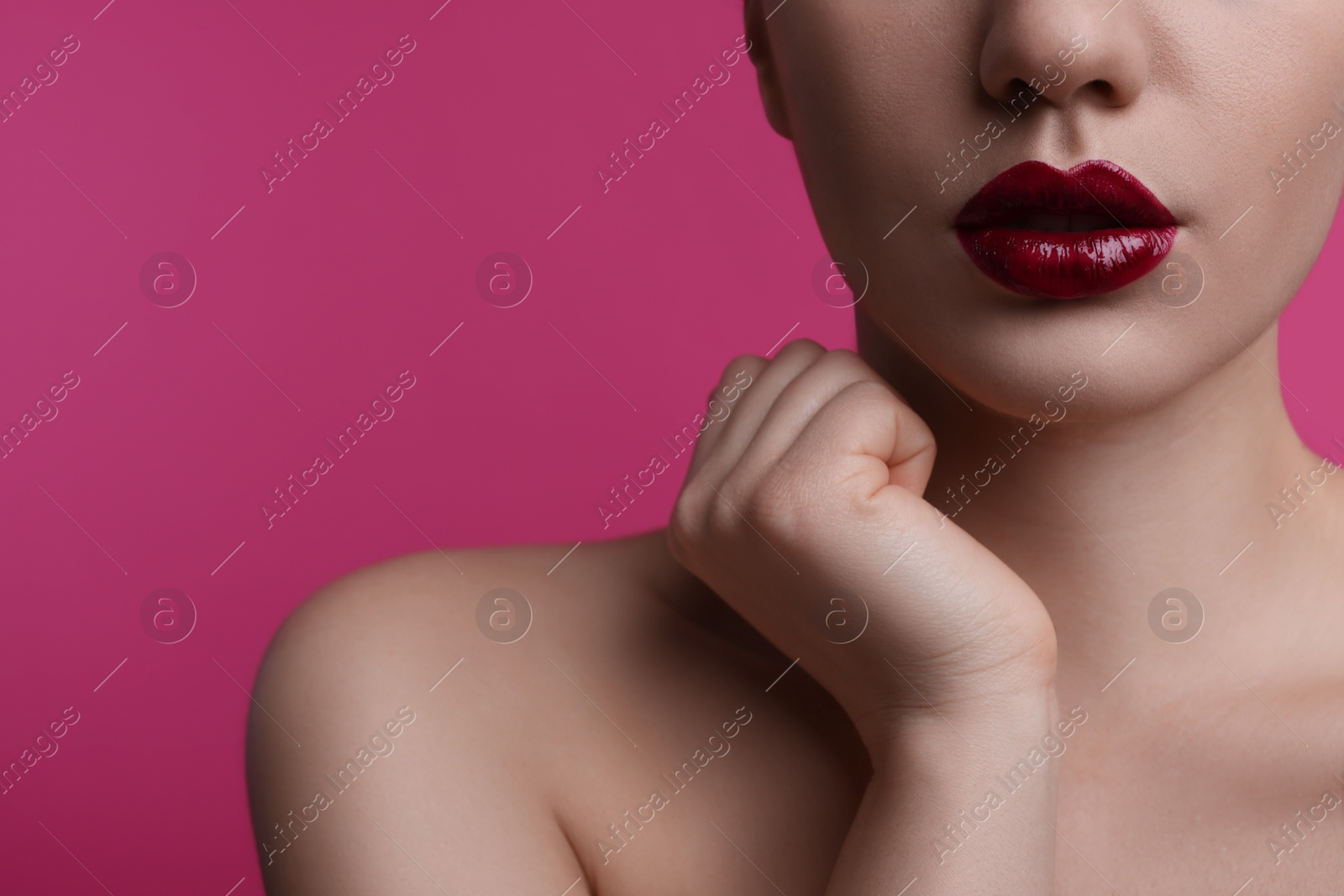 Photo of Closeup view of woman with beautiful full lips on pink background, space for text