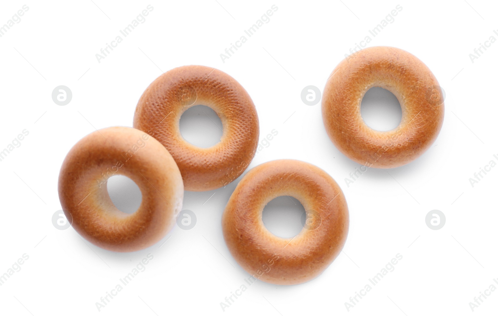 Photo of Tasty dry bagels (sushki) isolated on white, top view