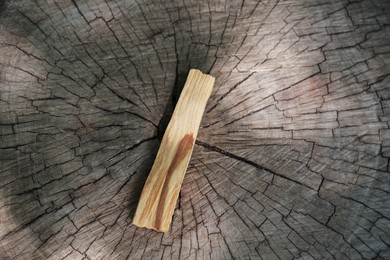 Palo santo stick on wooden stump, top view