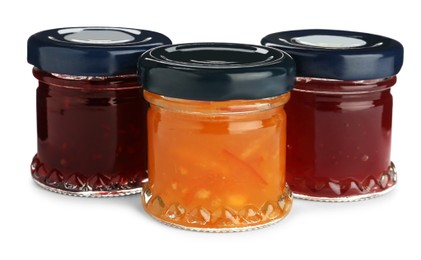 Jars with different jams on white background