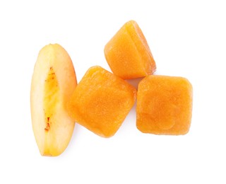 Frozen nectarine puree cubes and fruit on white background, top view