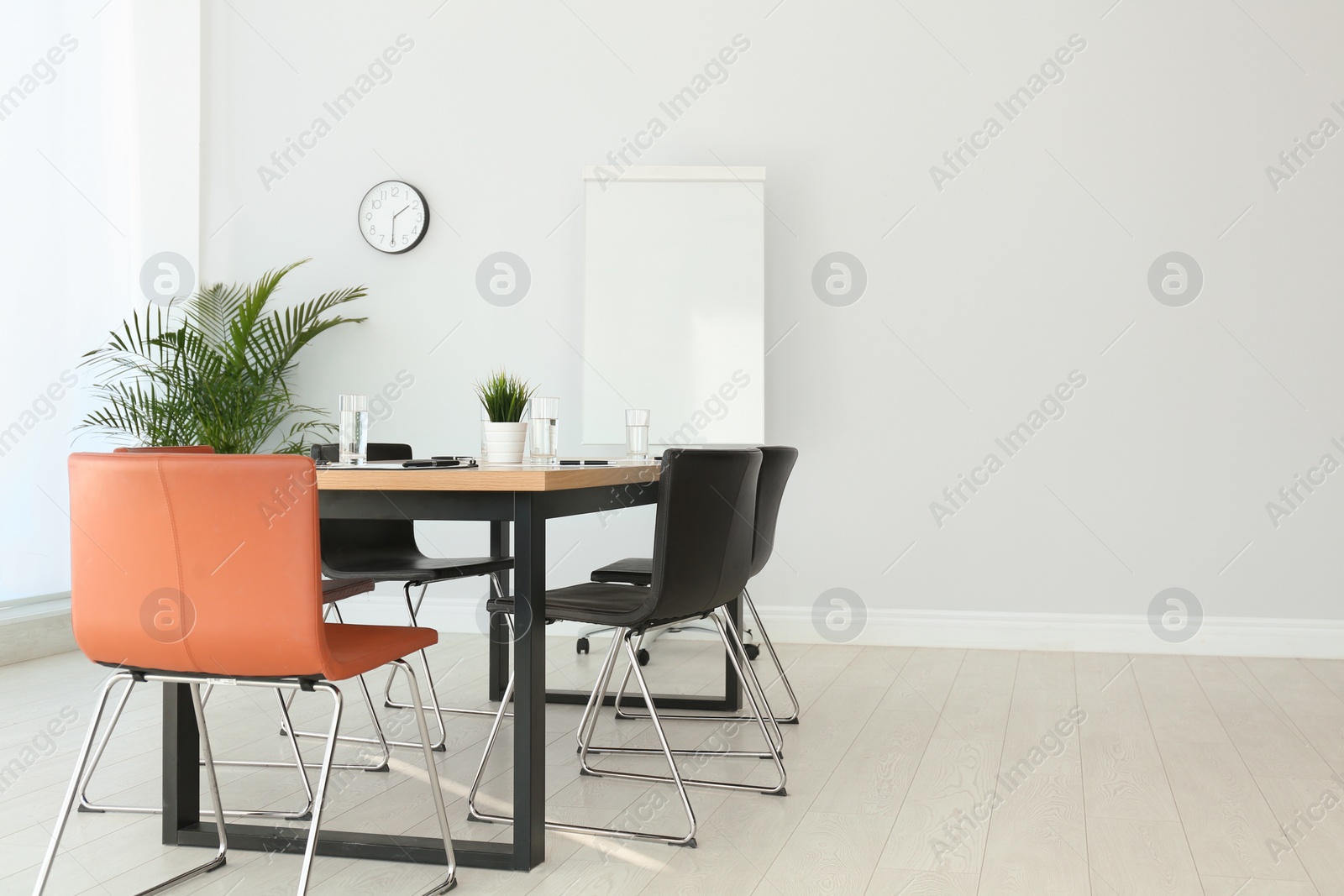 Photo of Simple office interior with large table and chairs