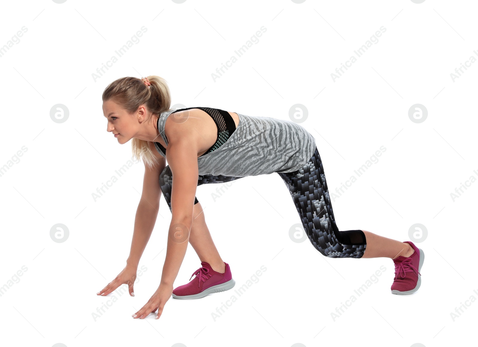 Photo of Young woman ready to run on white background