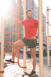 Photo of Man at outdoor gym on sunny day