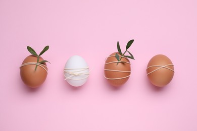 Photo of Beautifully decorated Easter eggs on pink background, flat lay