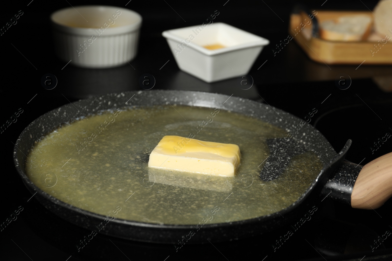 Photo of Melting butter in frying pan on cooktop