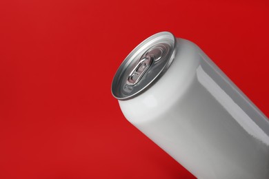 Photo of White can of energy drink on red background, closeup. Space for text