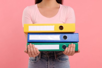 Photo of Woman with folders on pink background, closeup
