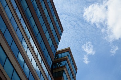 Photo of Modern building against blue sky, low angle view. Space for text