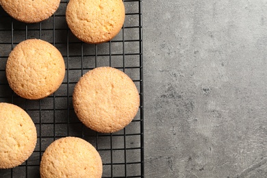 Photo of Baking grid with Danish butter cookies on grey background, top view. Space for text