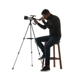 Photo of Astronomer looking at stars through telescope on white background
