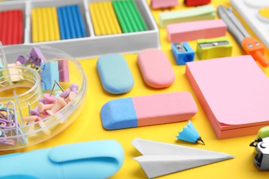 Photo of Many different school stationery on pale yellow background, closeup. Back to school