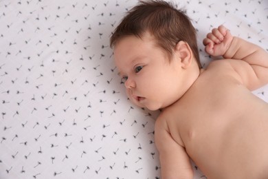 Photo of Cute little baby lying on blanket, top view with space for text. Bedtime
