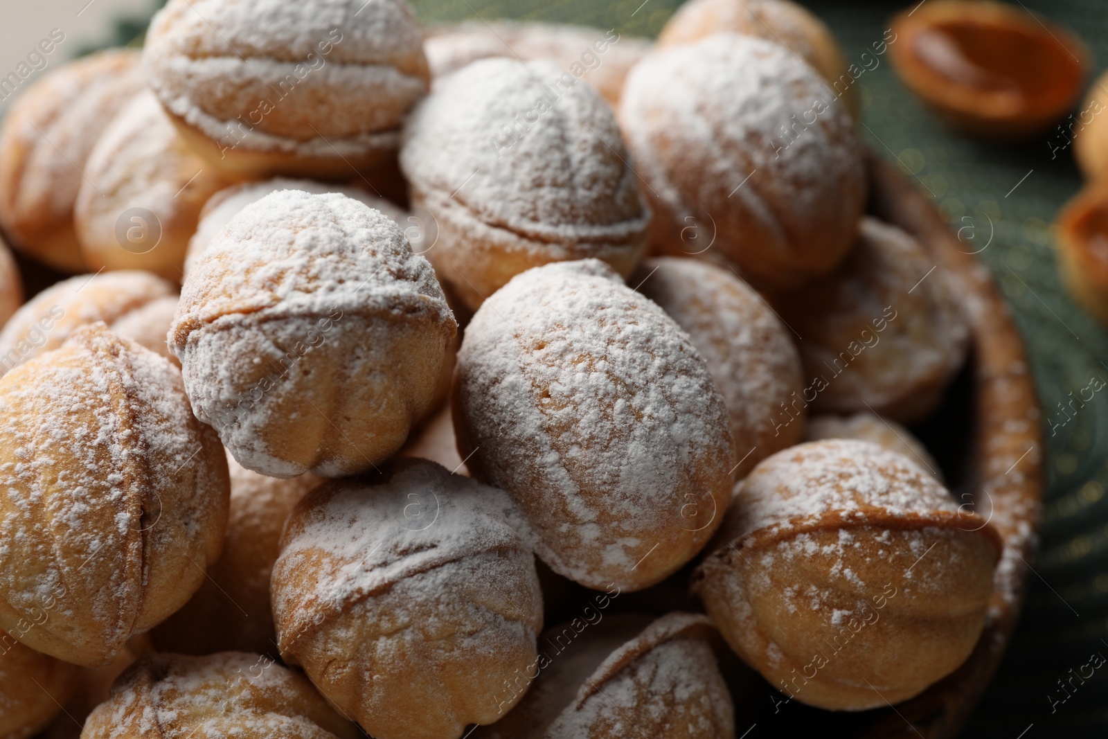 Photo of Bowl of delicious nut shaped cookies on table, closeup