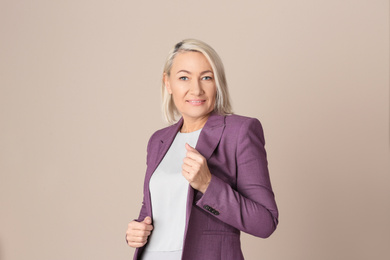 Photo of Portrait of beautiful mature woman on beige background