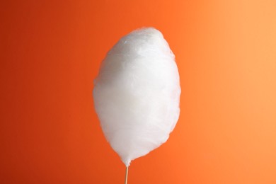 Photo of One sweet cotton candy on orange background