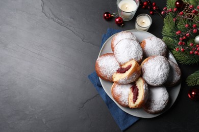 Photo of Delicious sweet buns with jam and decor on dark gray table, flat lay. Space for text