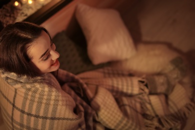 Photo of Young pretty woman with plaid resting at home. Winter season