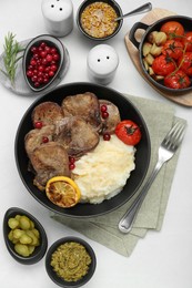 Photo of Tasty beef tongue pieces, berries, mashed potatoes and ingredients on white table, flat lay