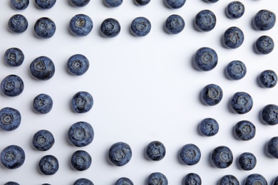 Photo of Frame of ripe blueberries on white background, flat lay with space for text